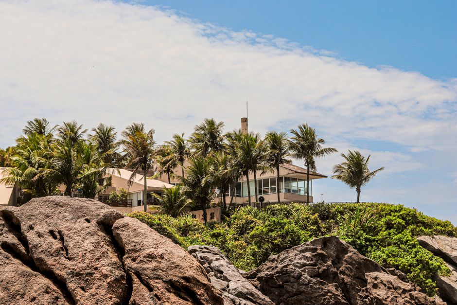 Stunning modern luxury home with an infinity pool overlooking the ocean in Mexico, representing the dream of investing in ...